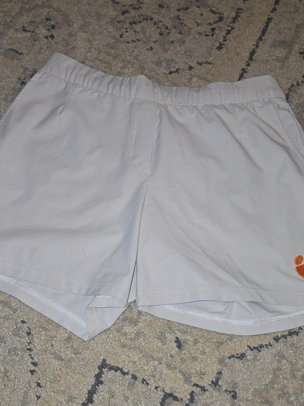 Nike Women’s Light Gray Golf Shorts with Orange Logo